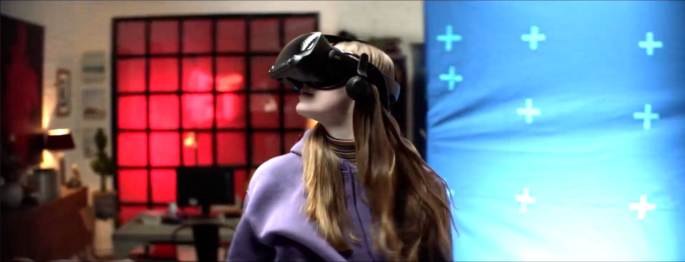 Original plate: a person wearing a VR headset in a room, partly in front of a blue screen.